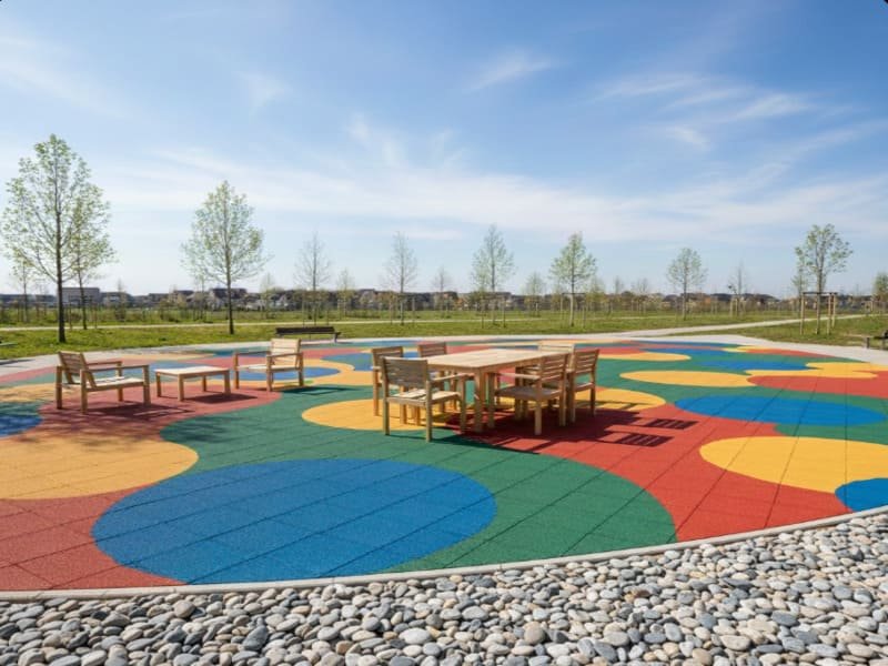 Worker compacting gravel subbase with a plate compactor